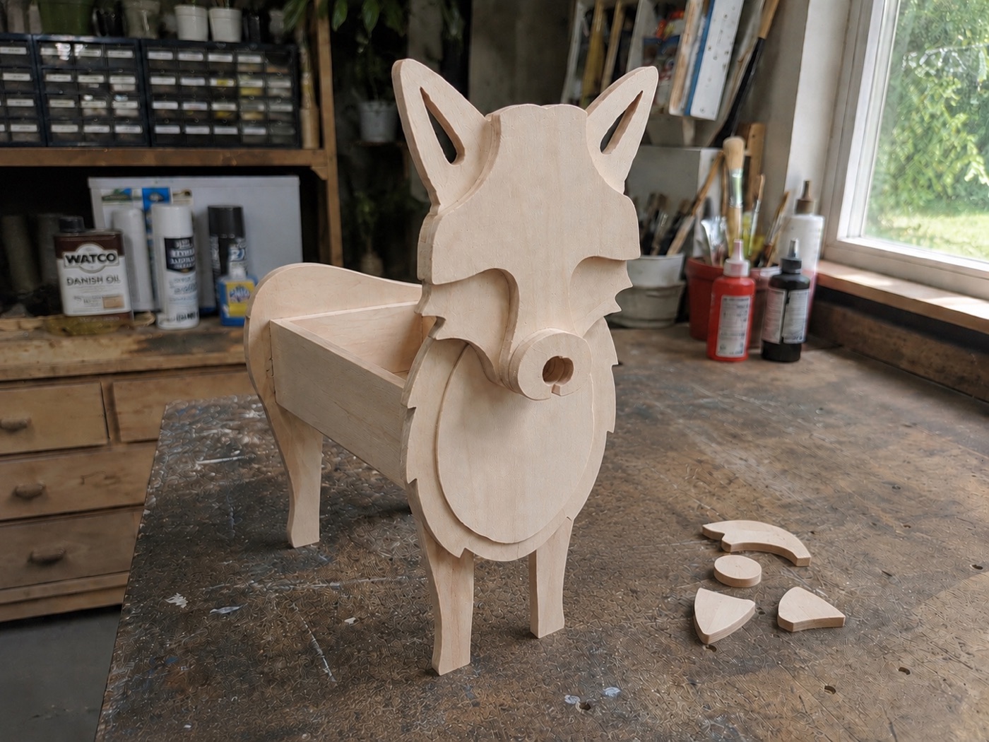 Kevin assembling the wooden pieces of a fox planter in the workshop