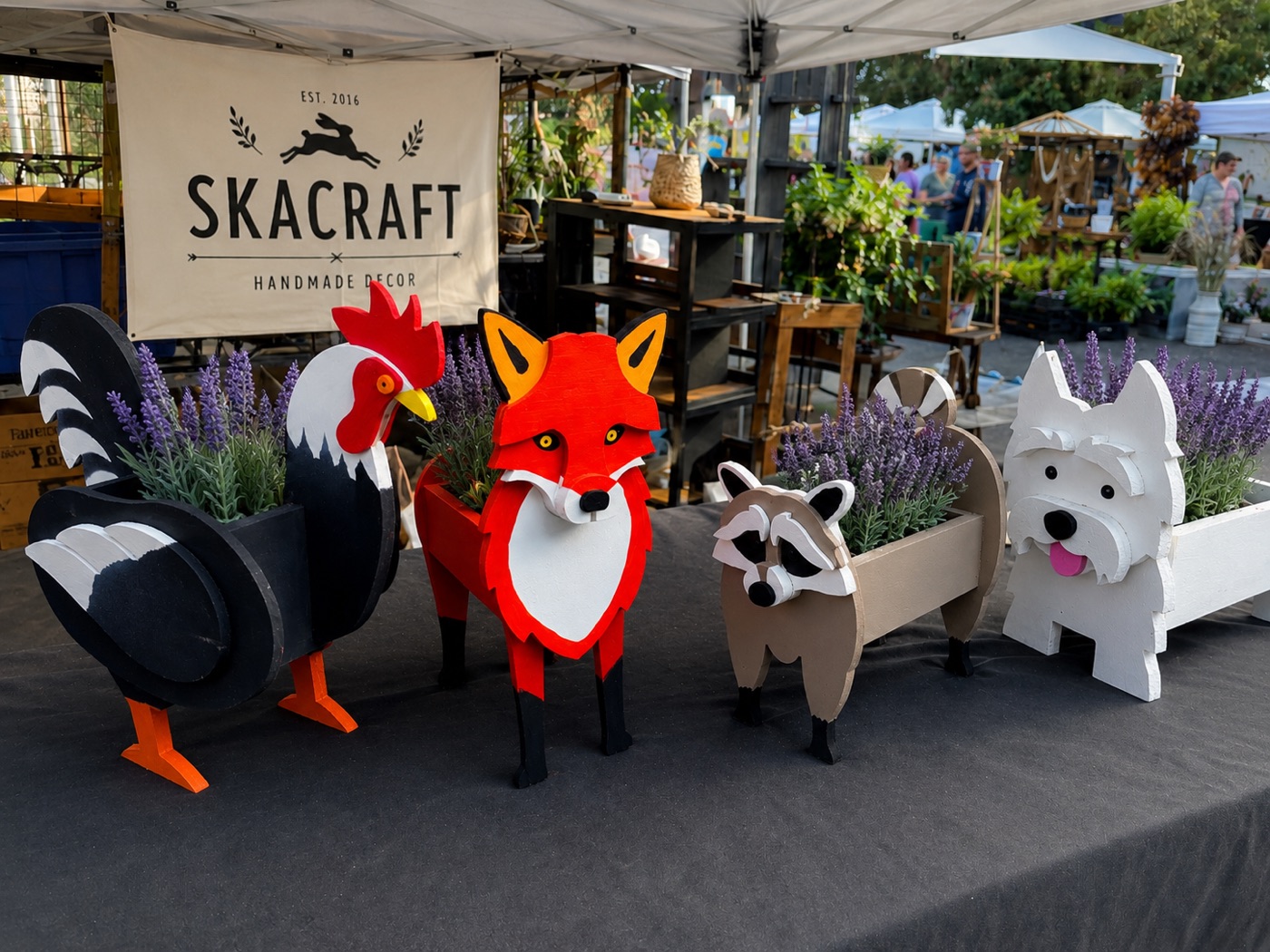 SKACRAFT animal planters displayed at the farmers market booth under the SKACRAFT banner